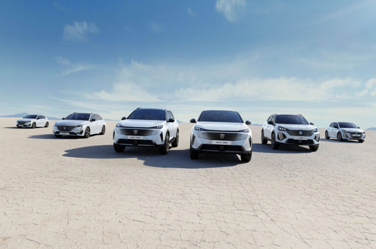 peugeot electric cars drive through a desert in formation