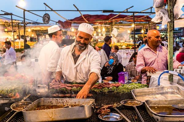 A cook at a food stall in Jemaa el Fnaa the main square of Marrakesh Morocco. Street food stalls in