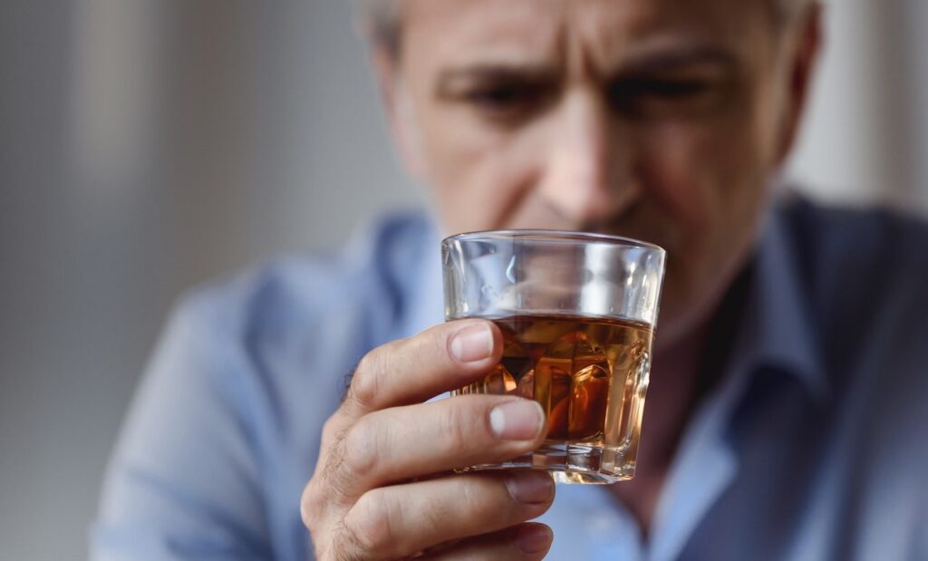 man drinking alcohol