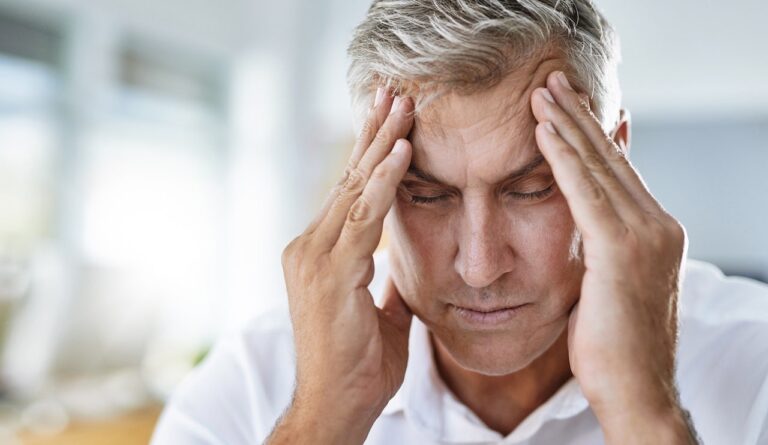 man holding head