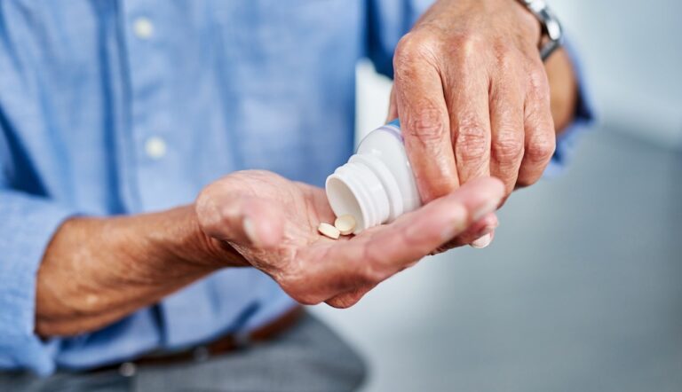 older man taking pills